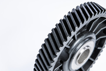 Black polymer gear camshaft with metal base. New spare part for an internal combustion engine on a gray background