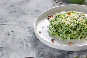 Green pasta with avocado, spinach and pine nuts