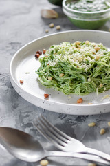 Green pasta with avocado, spinach and pine nuts