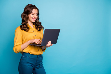 Portrait of her she nice attractive lovely cheerful cheery wavy-haired girl holding in hands laptop creating presentation isolated over bright vivid shine vibrant green blue turquoise color background - obrazy, fototapety, plakaty