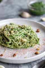 Green pasta with avocado, spinach and pine nuts