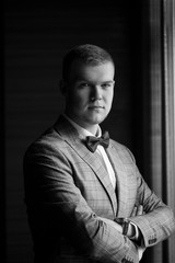 Groom in a beautiful plaid suit and bow-tie