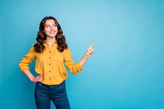Photo of amazing business lady indicating finger empty space interested advising new product low discount price wear yellow shirt trousers isolated blue color background