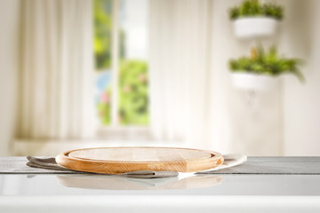 Desk of free space for your decoration and blurred background of kitchen.Copy space and sunny day. 