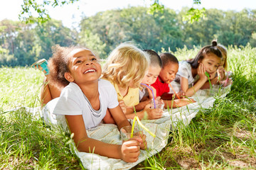 Multicultural children drink water together