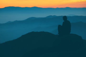 People sitting and watching the sunrise in the morning