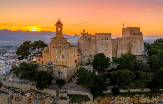 Aerial sunset view of Cullera castle and Sanctuary of the Virgen del Castillo above the popular summer resort vacation beach town near Valencia Spain