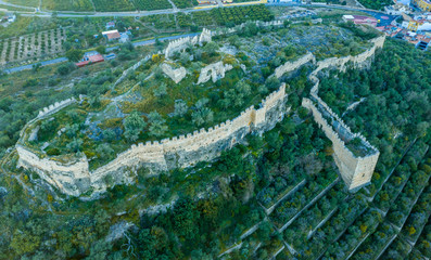 Aerial view of Corbera medieval Gothic castle in ruins on a hilltop near the coast with walls and a standalone tower in Spain  © tamas