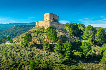 Obraz premium Aerial sunset view of Cullera castle and Sanctuary of the Virgen del Castillo above the popular summer resort vacation beach town near Valencia Spain