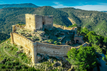 Aerial sunset view of Cullera castle and Sanctuary of the Virgen del Castillo above the popular summer resort vacation beach town near Valencia Spain