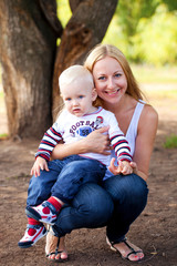 Fototapeta premium Young mother holds on hands of his two year old son