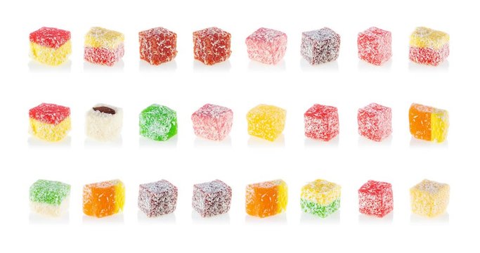 Multi-colored sweets are moving at different speeds on a white background. Turkish dessert Turkish delight flickering on a white background