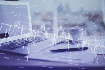 Forex graph hologram on table with computer background. Double exposure. Concept of financial markets.