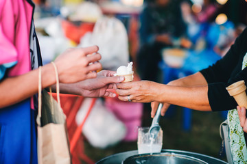The hands of the poor are waiting to receive food from the rich, compassionate, free food donations to the homeless