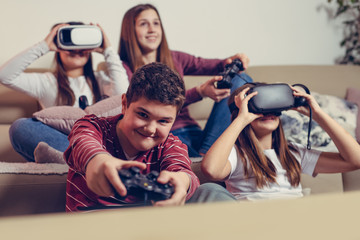 Teenagers playing video game at home.