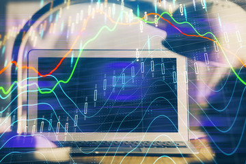 Financial market graph hologram and personal computer on background. Double exposure. Concept of forex.