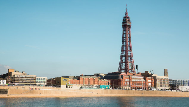 Blackpool, England, 19/09/2019 Beautiful landscape image of the the famous Blackpool Tower on the seaside promenade of the north west, a hotspot for holidays and British tourism. Blue sky and water