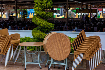 Wooden tables and chairs standing near a restaurant