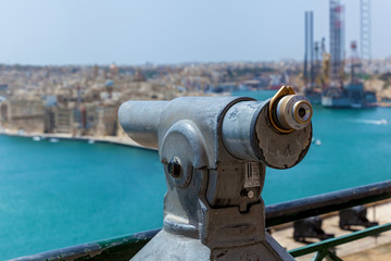 The coin-operated monocular points out on a coastal city