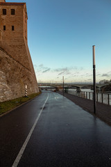 Beautiful river embankment overlooking the medieval castle and the fortress wall. Walk in the early morning in winter