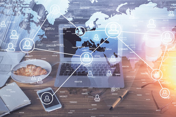 Computer on desktop with social network theme icon. Multi exposure. Concept of international connections.