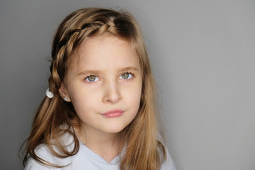 Close-up portrait of beautiful upset little girl