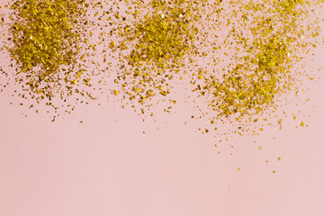 pink background with gold sequins. the concept of a holiday, Valentine's Day, women's day, birthday. place for your text, top view.