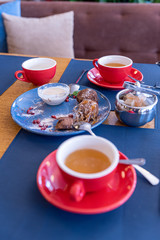 Chocolate cakes on a blue plate and red cups