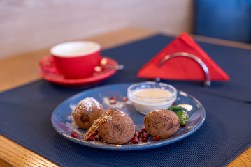 Chocolate cakes on a blue plate and red cups