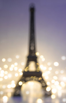 Abstract background with Eiffel tower and lights. Vertical picture, disfocused