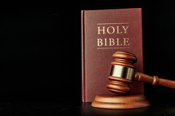 judge gavel with holy bible on black background
