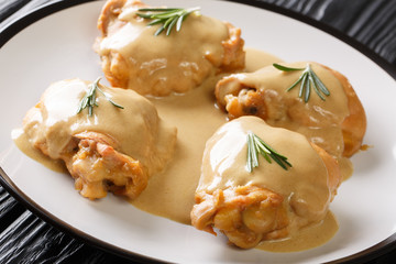 Tasty chicken thighs baked with Dijon mustard and maple syrup close-up in a plate. horizontal
