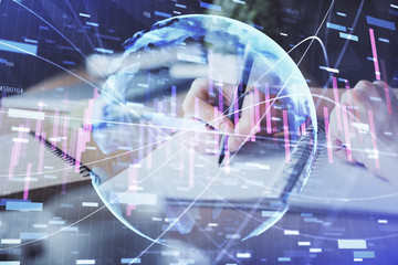 Financial forex graph drawn over hands taking notes background. Concept of research. Multi exposure