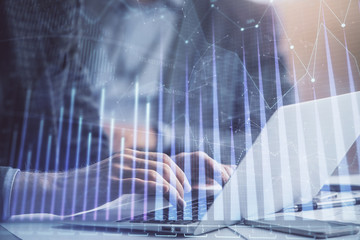 Double exposure of market chart with man working on computer on background. Concept of financial analysis.