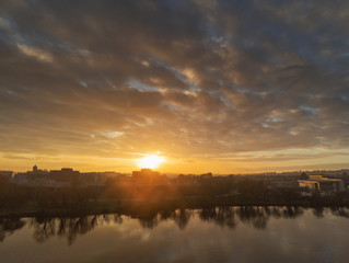 Sunset over town, Silhouettes of a office building reflects in a water. River Corrib Galway city Ireland.