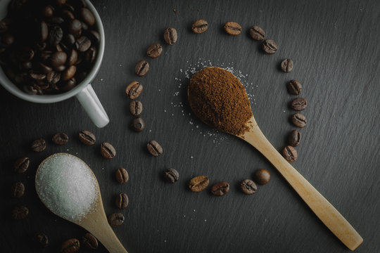 Cup Of Coffee With Coffee Seeds Shaped Like Circles With Sugar Spoons And Coffee Inside,stone Bottom, Zenith , Dark Food