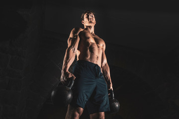 Fototapeta na wymiar Fit muscular bodybuilder man posing on dark background
