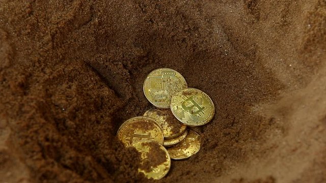 Man burying   bit coin in sand, out door  Chiangmai Thailand