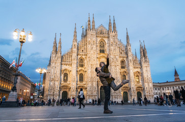 Romantic young couple embracing in front of the Duomo, Milan, Italy - 319417129