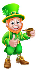 A Leprechaun St Patricks Day cartoon character mascot holding a pipe and giving a thumbs up