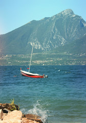 Beautiful sunny day on the lake: water, boat, mountain