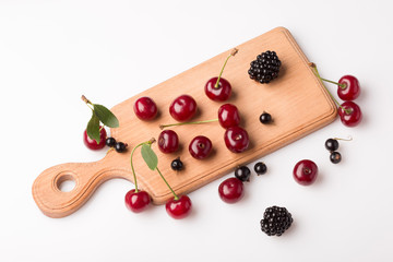 Naklejka na ściany i meble Still life board with berries.