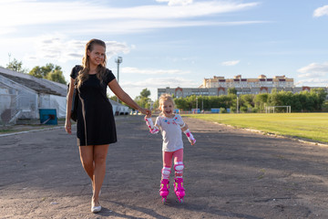 Child learns to roller skate. Roller skating