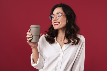 Woman in glasses drinking coffee isolated