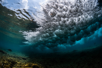 Underwater view of the wave breaking over the coral reef