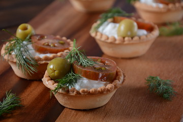 Sweet potato and carrot soup served with sour cream in wooden bowl. Orange vegetable soup concept. Vegan food
