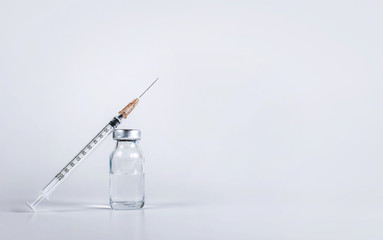 syringe and glass vial with medicine for injection close-up, copy space