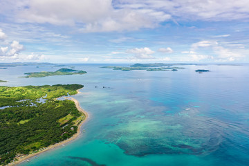 Fototapeta na wymiar Seascape with islands in the early morning, view from above. Caramoan Islands, Philippines. Malay archipelago with reefs and islands.