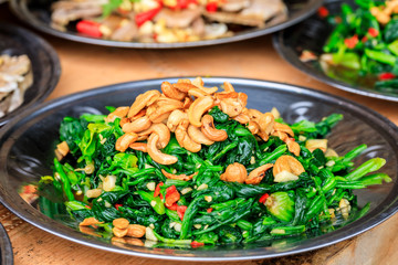 Delicious spinach cold dish,the ingredients are chili and garlic with cashews.Chinese food.