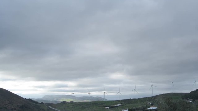 Wind turbines moving a cloudy day